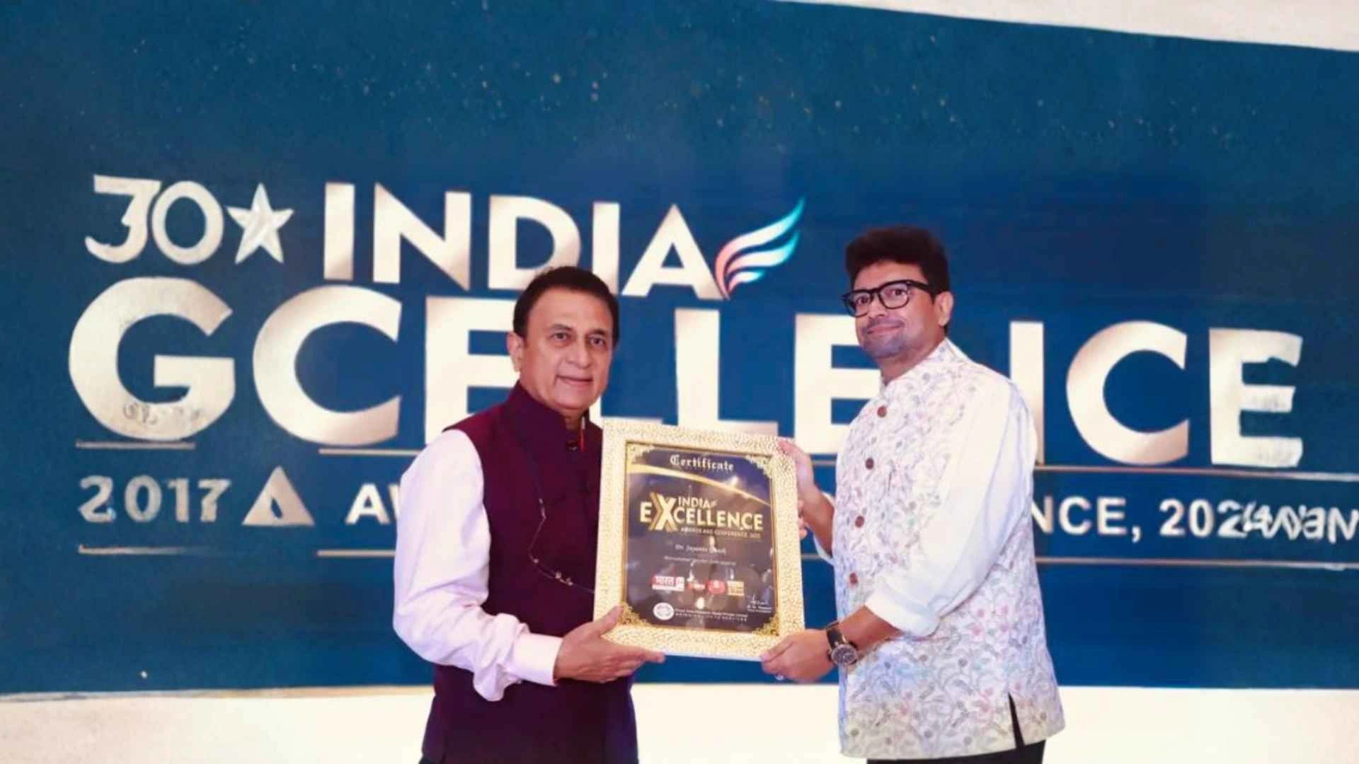 Dr. Jayanta Ghosh receiving the India Excellence Award certificate on stage